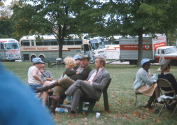 Cast, including Dan Dubbins (Harley Davis) and Dana Elcar (Kirky) seated center, in front of production vehicles.
